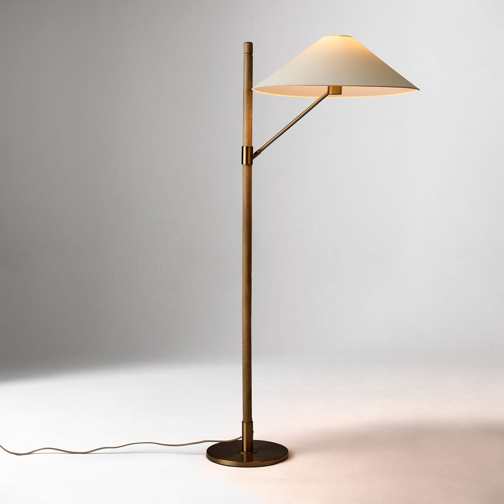 Decor your interior with the Devon Floor Lamp (64"), a refined fusion of antique brass, warm ash wood, and delicate paper. Designed for both residential and contract-grade commercial settings, it offers elegance, durability, and ambient lighting in one striking piece.